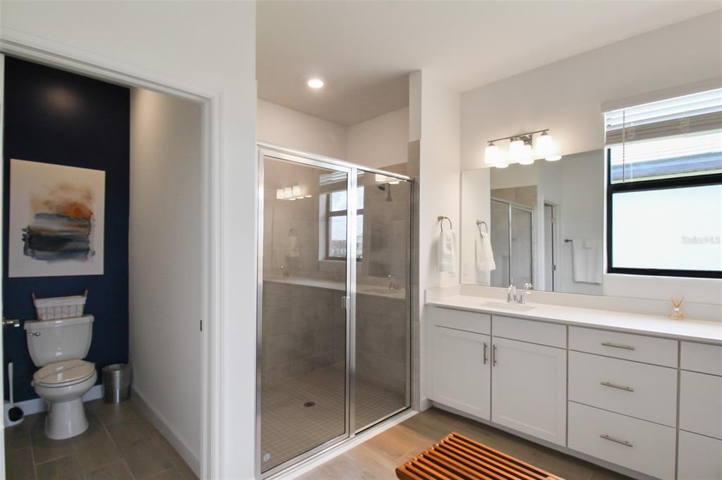 15025 Sea Salt Way Bradenton, FL 34211 - Photo 46 of 64 a bathroom with a sink a toilet and shower