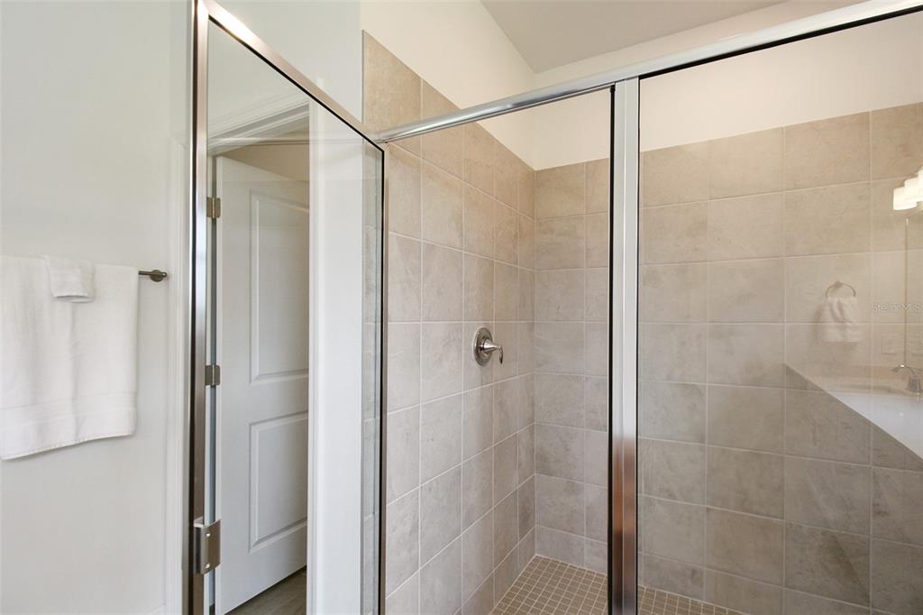 15025 Sea Salt Way Bradenton, FL 34211 - Photo 47 of 64 a bathroom with a glass shower door