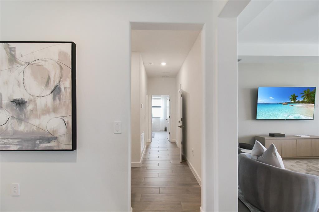 15025 Sea Salt Way Bradenton, FL 34211 - Photo 50 of 64 a view of a hallway with two couches and a flat screen tv