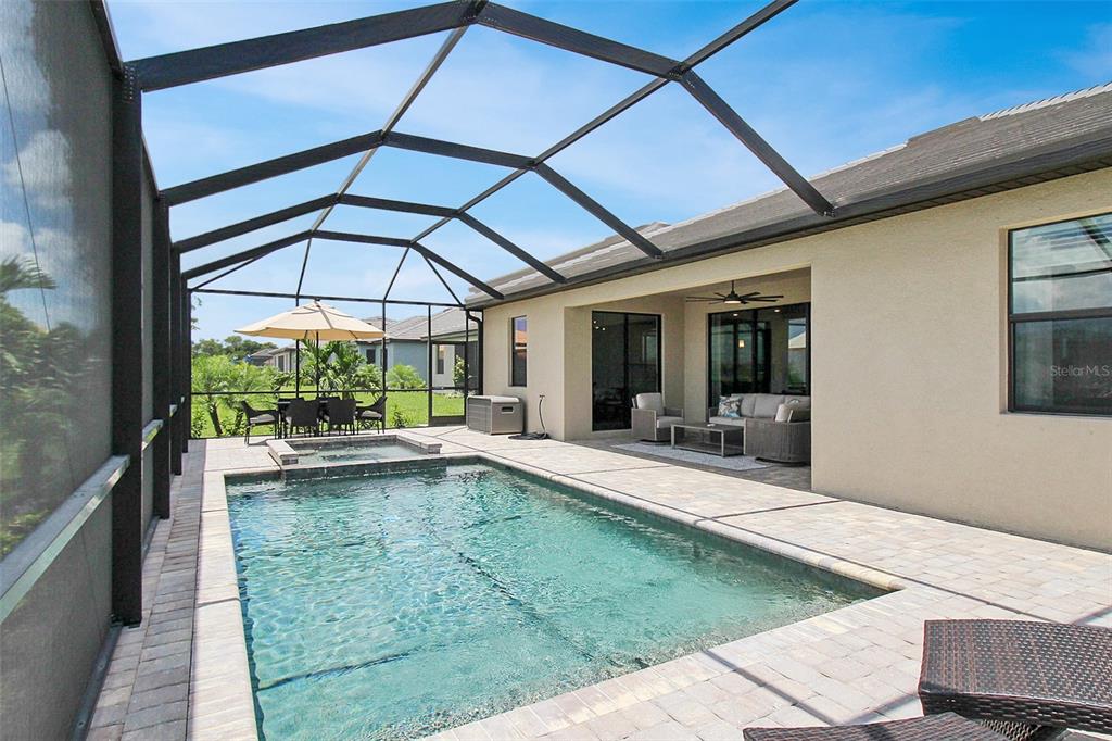 15025 Sea Salt Way Bradenton, FL 34211 - Photo 64 of 64 a view of a patio with a table and chairs under an umbrella