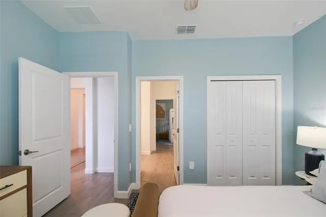 a view of a hallway with wooden floor and a living room