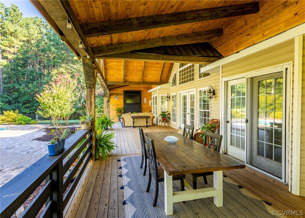 5776 Moore Creek Road Powhatan, VA 23139 - Photo 11 of 45 a view of a patio with table and chairs and wooden floor