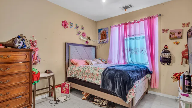 a bedroom with a bed and a window