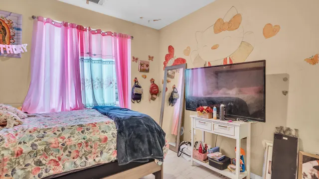 a bedroom with a bed and a flat screen tv