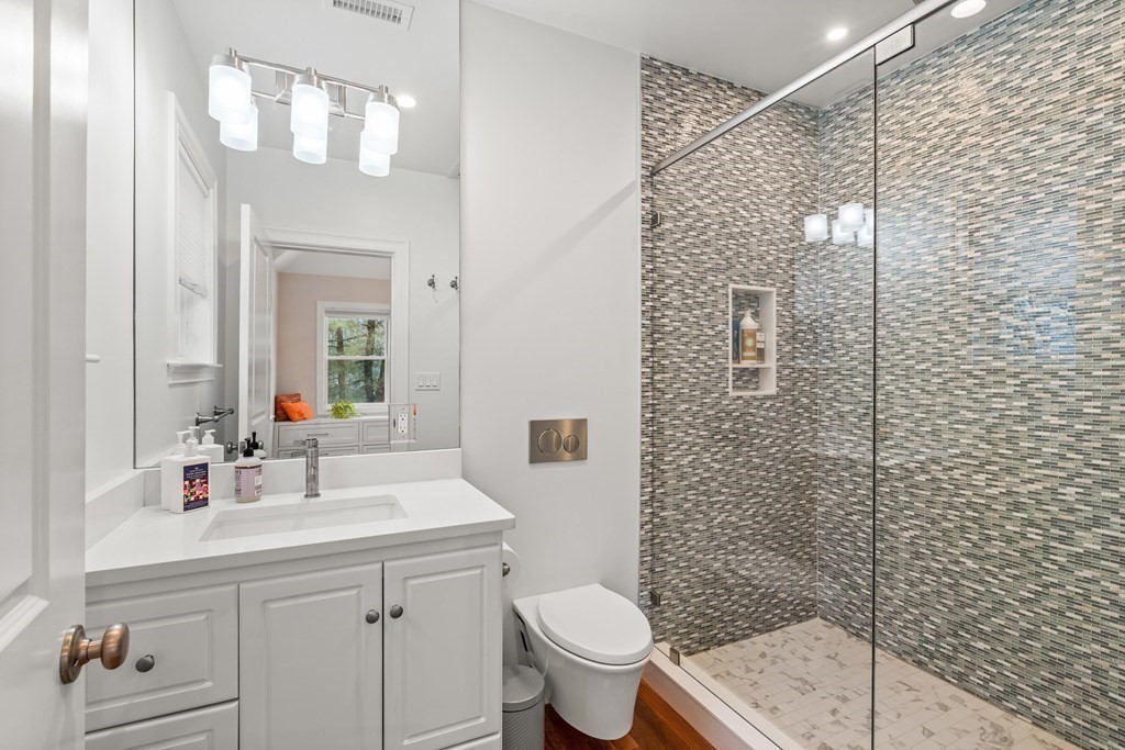 351 Otis Street Newton, MA 02465 - Photo 12 of 30 a bathroom with a sink a toilet and shower