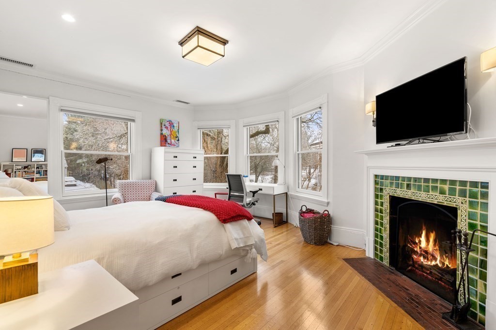 351 Otis Street Newton, MA 02465 - Photo 14 of 30 a bedroom with a bed and a flat screen tv