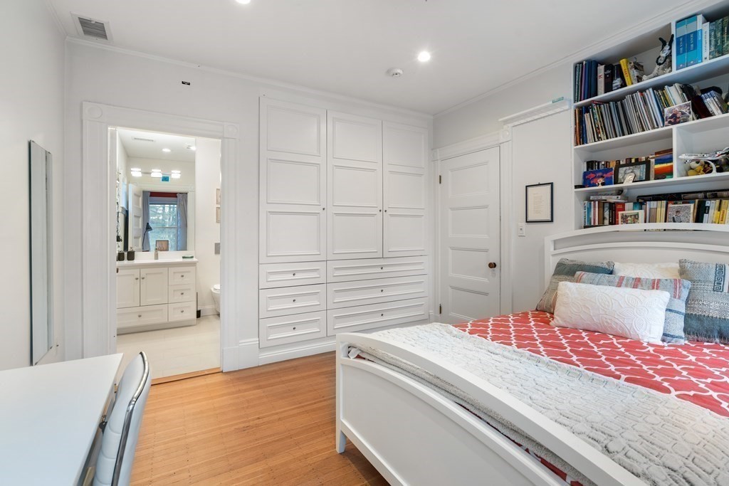 351 Otis Street Newton, MA 02465 - Photo 18 of 30 a bedroom with a bed and a book shelf