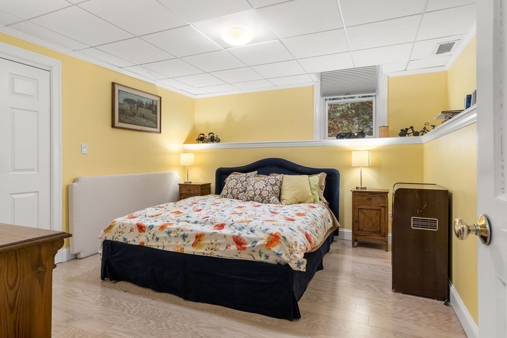 351 Otis Street Newton, MA 02465 - Photo 26 of 30 a bedroom with a bed and wooden floor