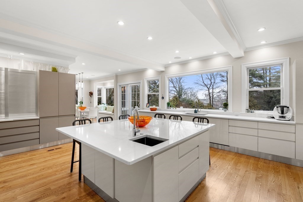 351 Otis Street Newton, MA 02465 - Photo 3 of 30 a kitchen with a sink a stove and chairs