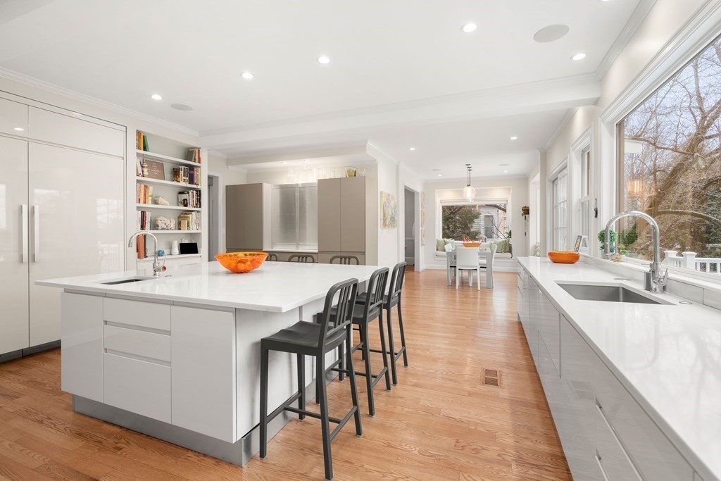 351 Otis Street Newton, MA 02465 - Photo 4 of 30 a large kitchen with kitchen island a large counter top space a sink stainless steel appliances and cabinets