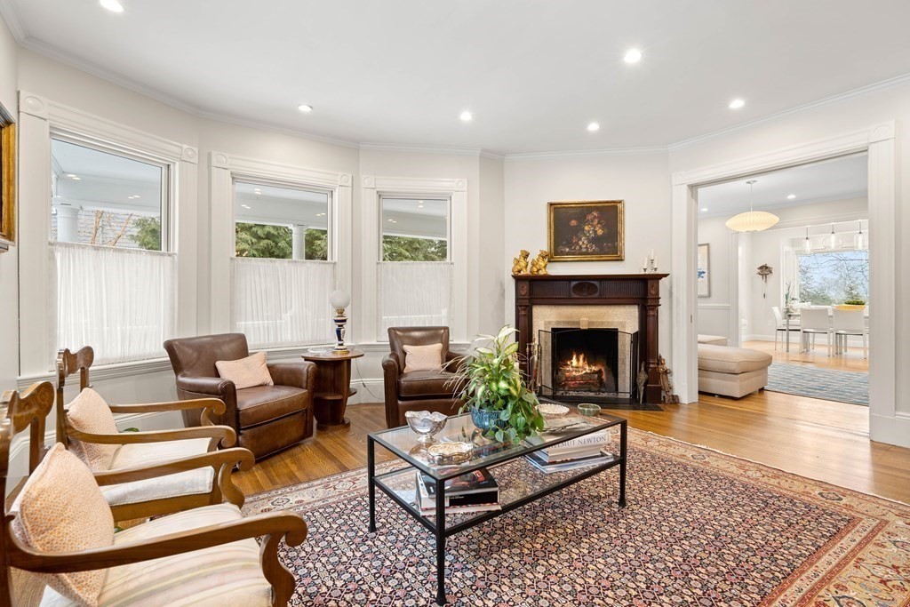 351 Otis Street Newton, MA 02465 - Photo 7 of 30 a living room with furniture a rug and a fireplace