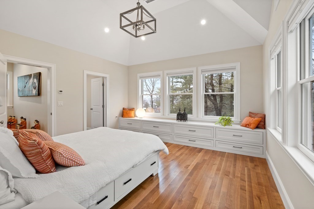 351 Otis Street Newton, MA 02465 - Photo 10 of 30 a bedroom with a bed and wooden floor