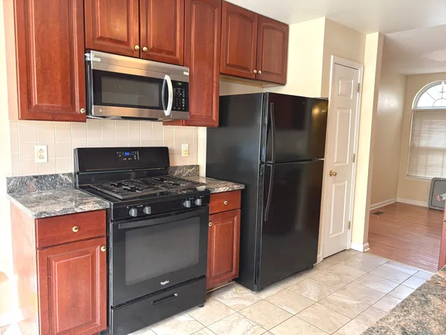 a view of a kitchen with a sink cabinet and a living room