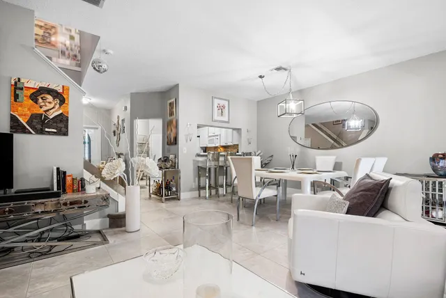 a living room with furniture a rug and white walls