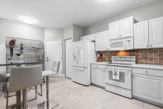a kitchen with stainless steel appliances a refrigerator sink and cabinets