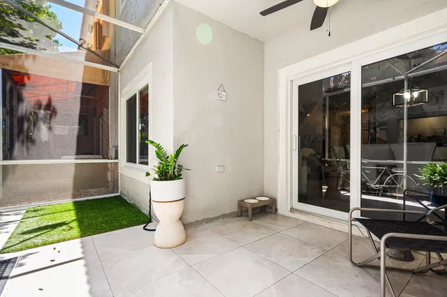 a view of a patio with table and chairs and potted plants