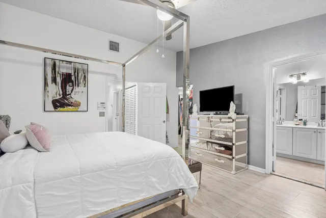 a bedroom with a bed and a flat screen tv