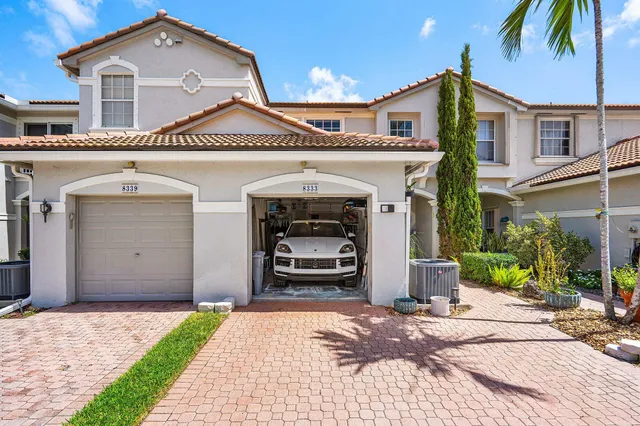 a front view of a house with a yard and garage