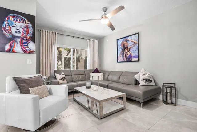 a living room with furniture and a large window