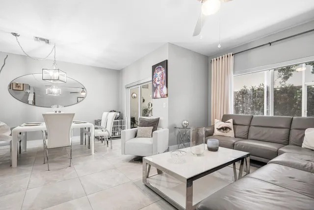 a living room with furniture a rug and a large window