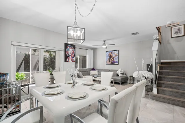 a view of a dining room with furniture wooden floor and chandelier