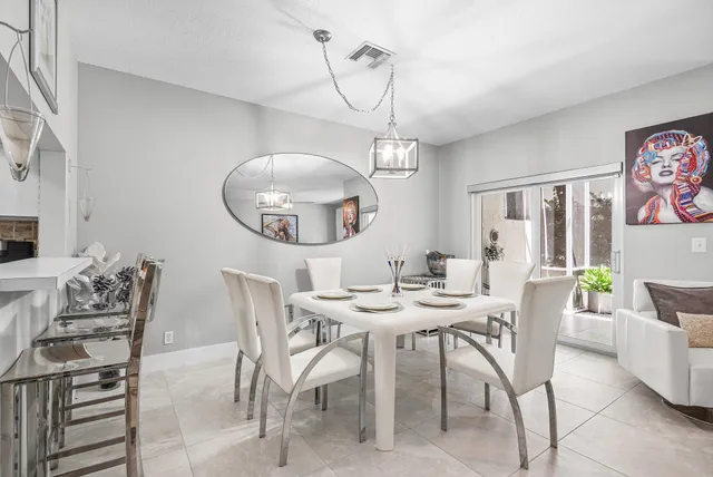 a view of a dining room with furniture and chandelier