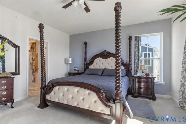 a bedroom with a bed and large windows