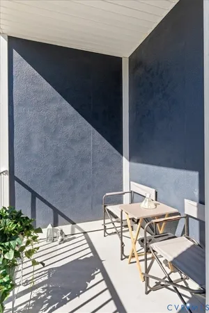 a balcony with table and chairs