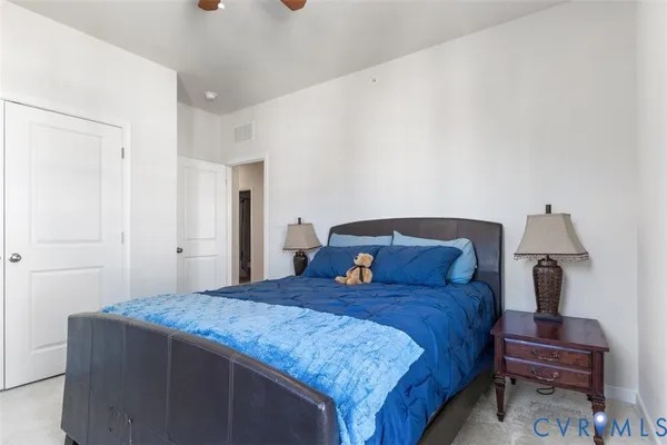 a bedroom with a bed and a lamp on table