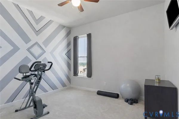 a front view of a building with cars parked