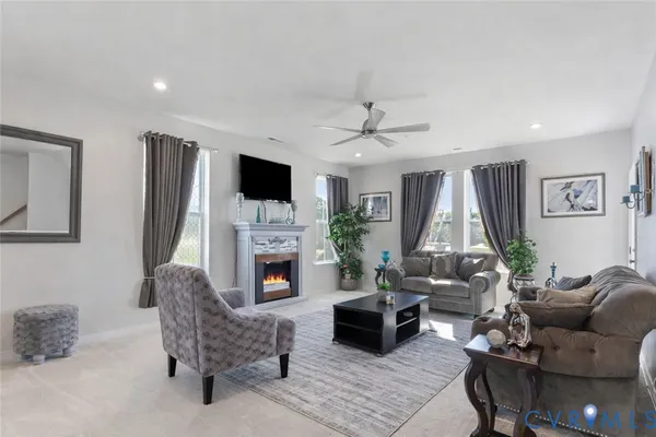 a living room with furniture fireplace and a flat screen tv