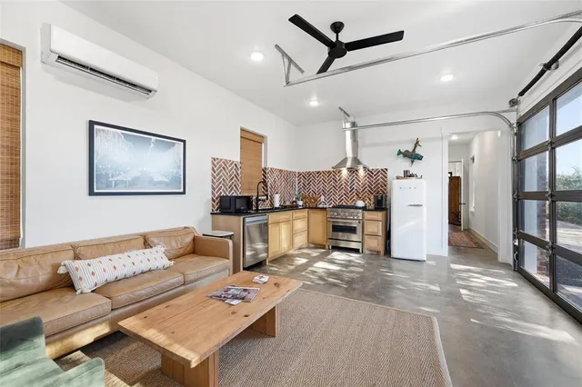 a living room with furniture and kitchen view
