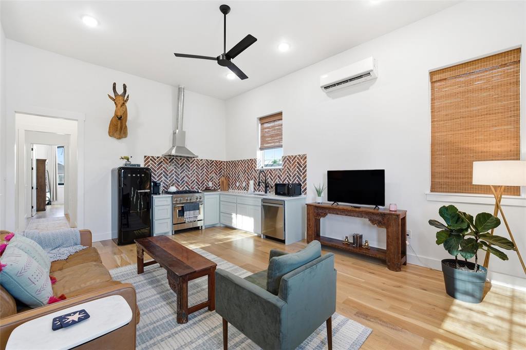 632 South 7th Street Waco, TX 76706 - Photo 8 of 10 a living room with furniture a fireplace and a flat screen tv