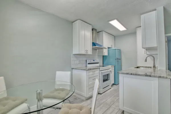 a kitchen with stainless steel appliances granite countertop a sink and cabinets