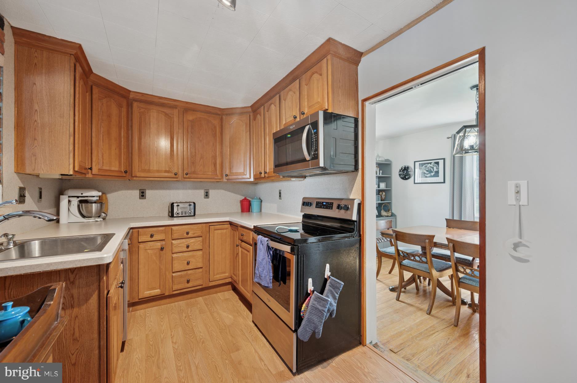 104 Scheivert Avenue Aston, PA 19014 - Photo 8 of 20 a kitchen with stainless steel appliances granite countertop a stove top oven a sink dishwasher a refrigerator and cabinets with wooden floor