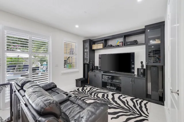 a living room with furniture and a ceiling fan
