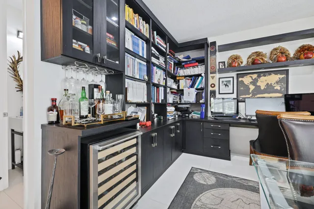 a view of patio with chairs and tables with potted plants