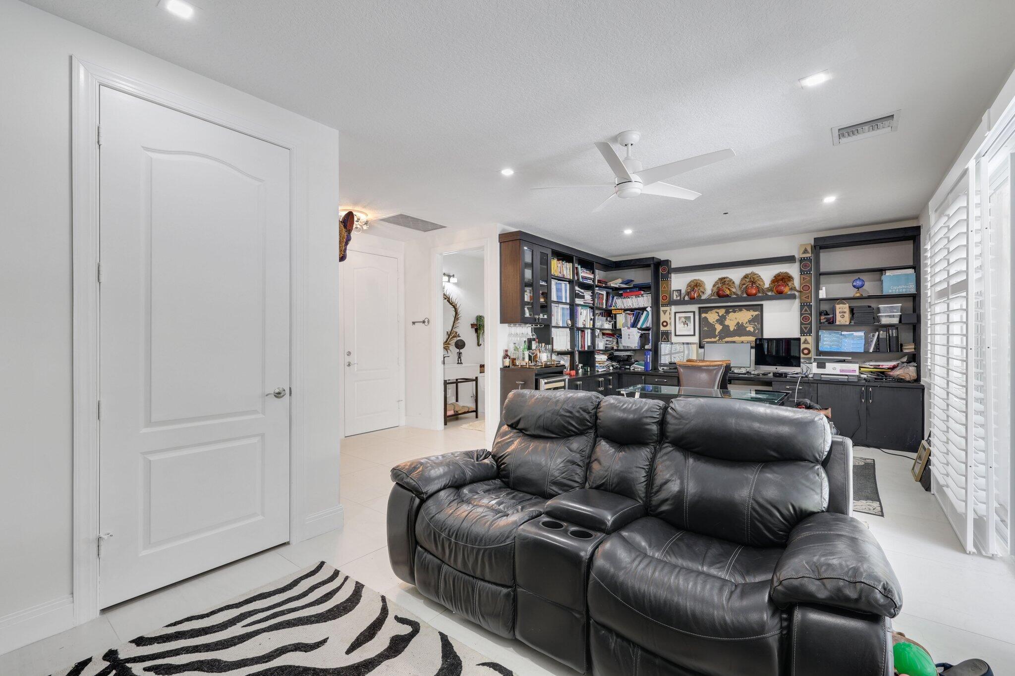 5530 Northeast Trieste Terrace, Unit 5530 Boca Raton, FL 33487 - Photo 14 of 57 a living room with furniture and a ceiling fan