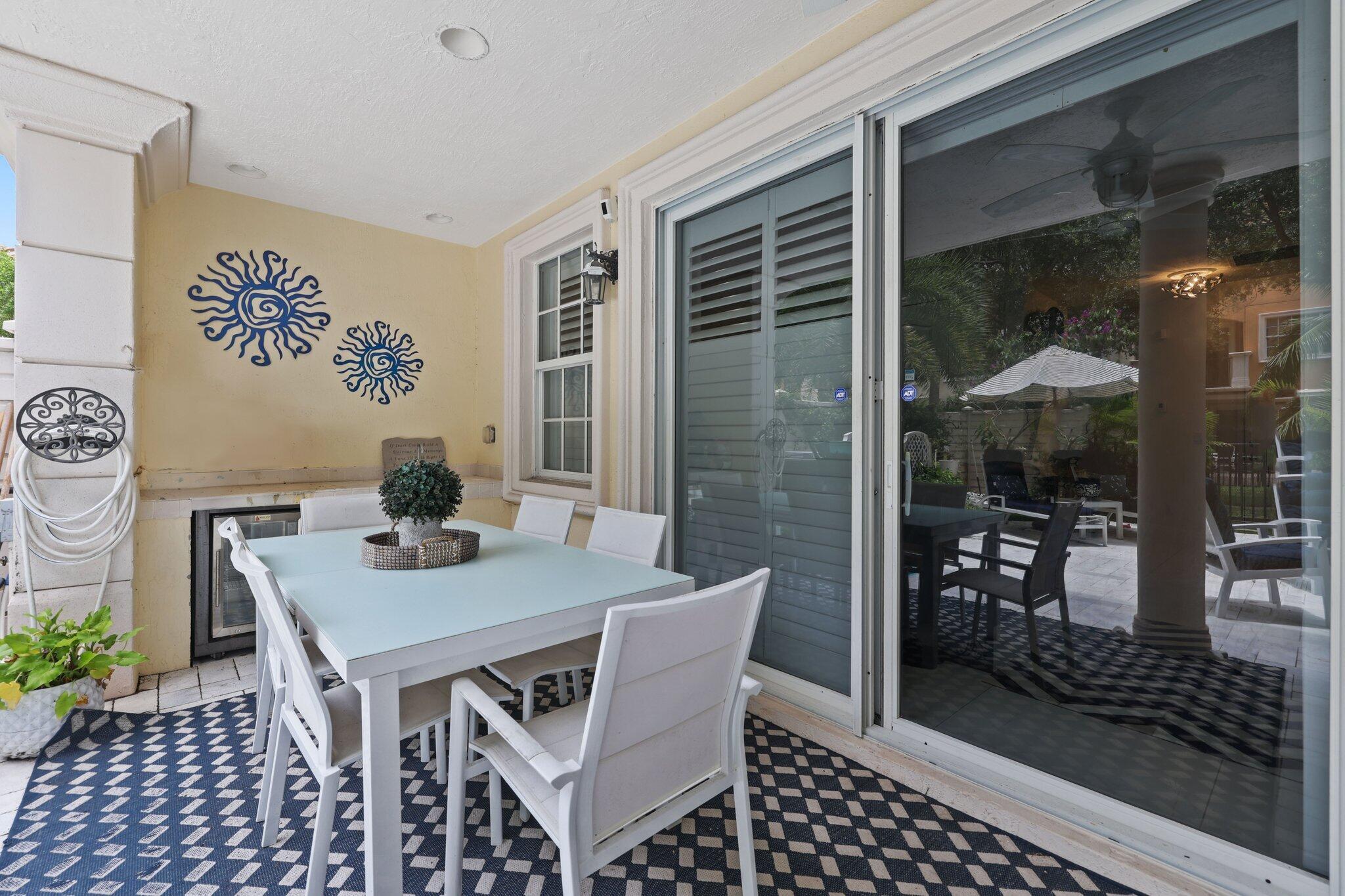 5530 Northeast Trieste Terrace, Unit 5530 Boca Raton, FL 33487 - Photo 15 of 57 a view of a dining room that has a table and chairs
