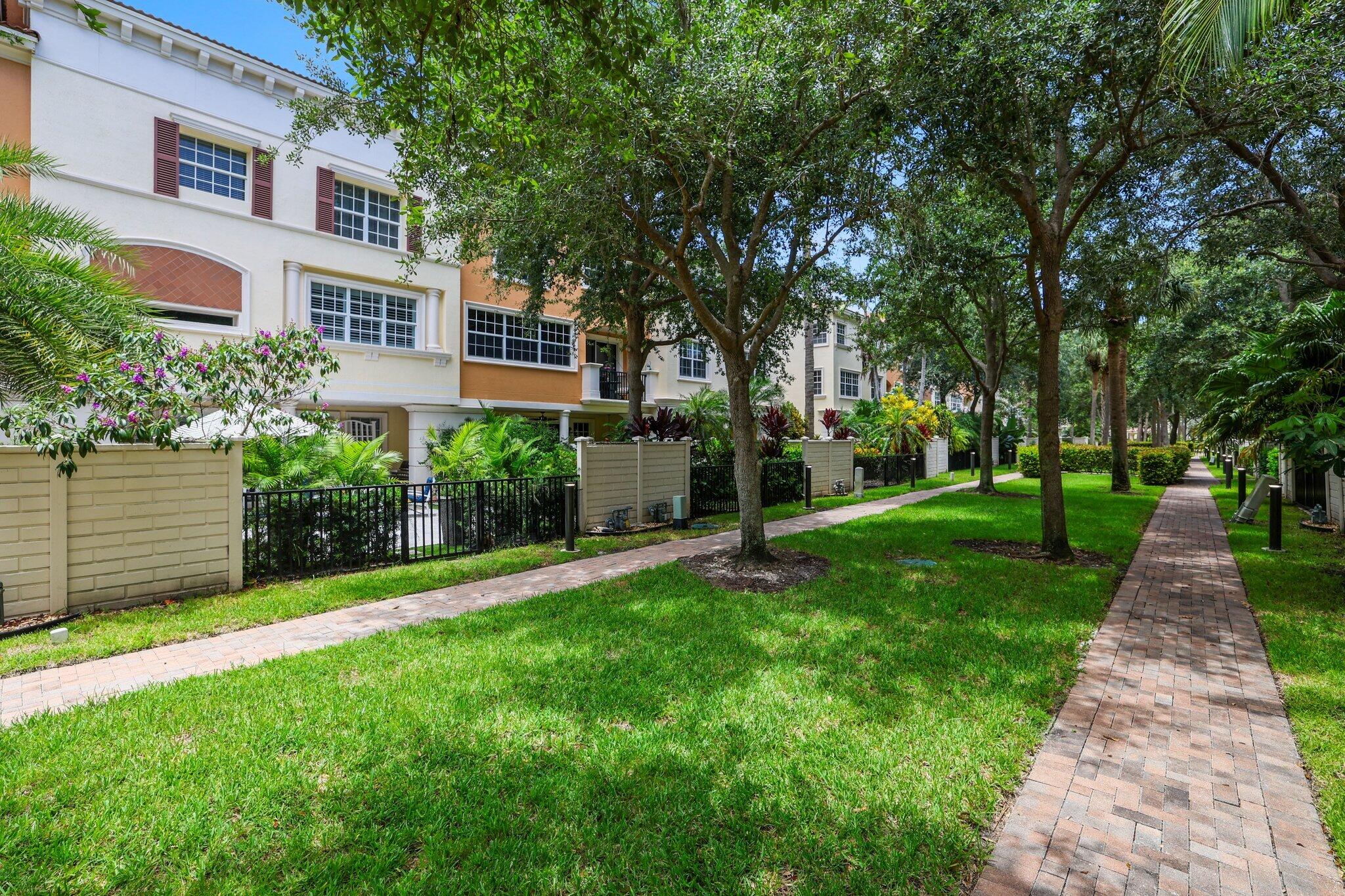 5530 Northeast Trieste Terrace, Unit 5530 Boca Raton, FL 33487 - Photo 22 of 57 a view of a pathway with a garden