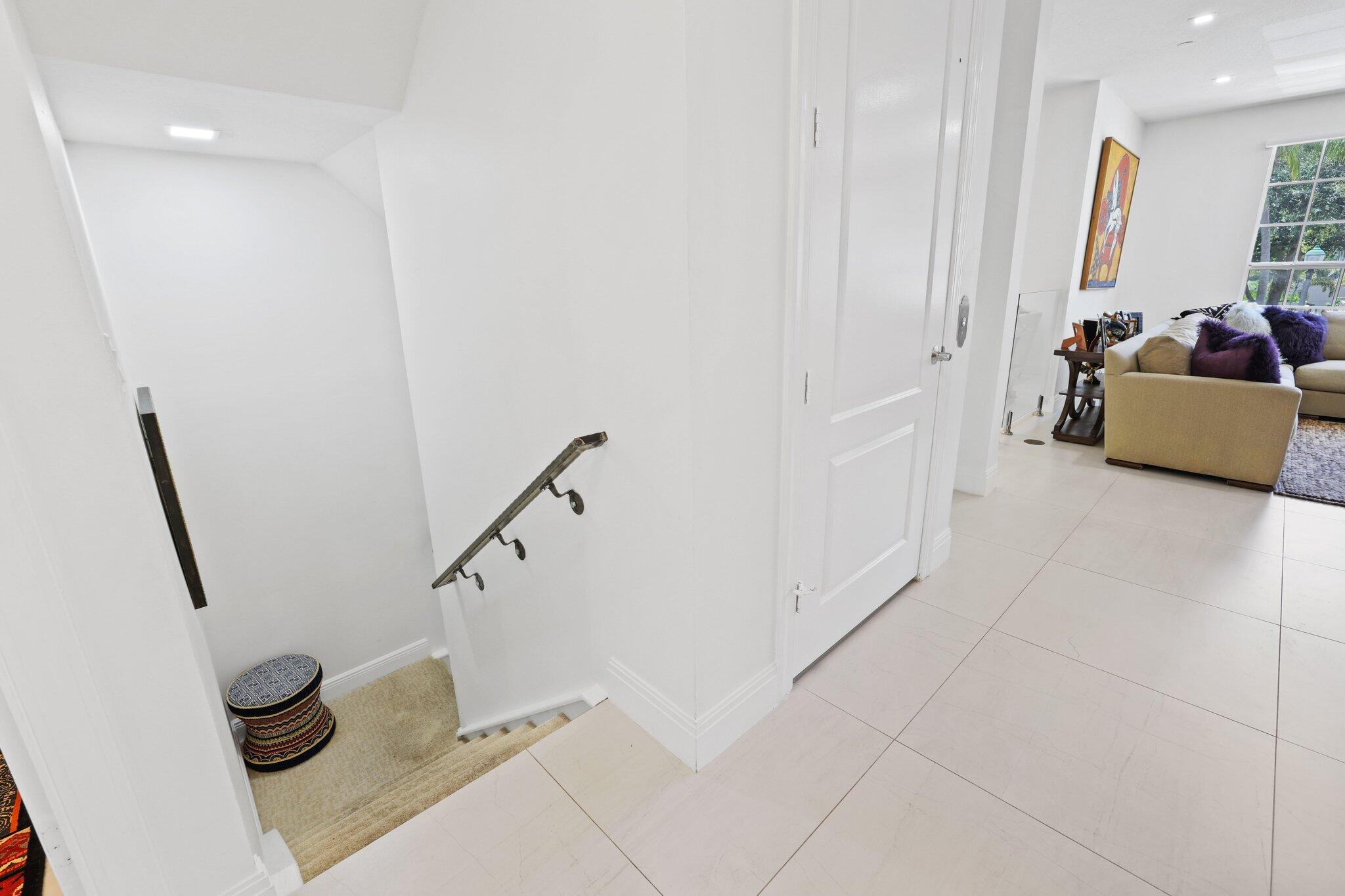 5530 Northeast Trieste Terrace, Unit 5530 Boca Raton, FL 33487 - Photo 23 of 57 a living room with furniture and a gate