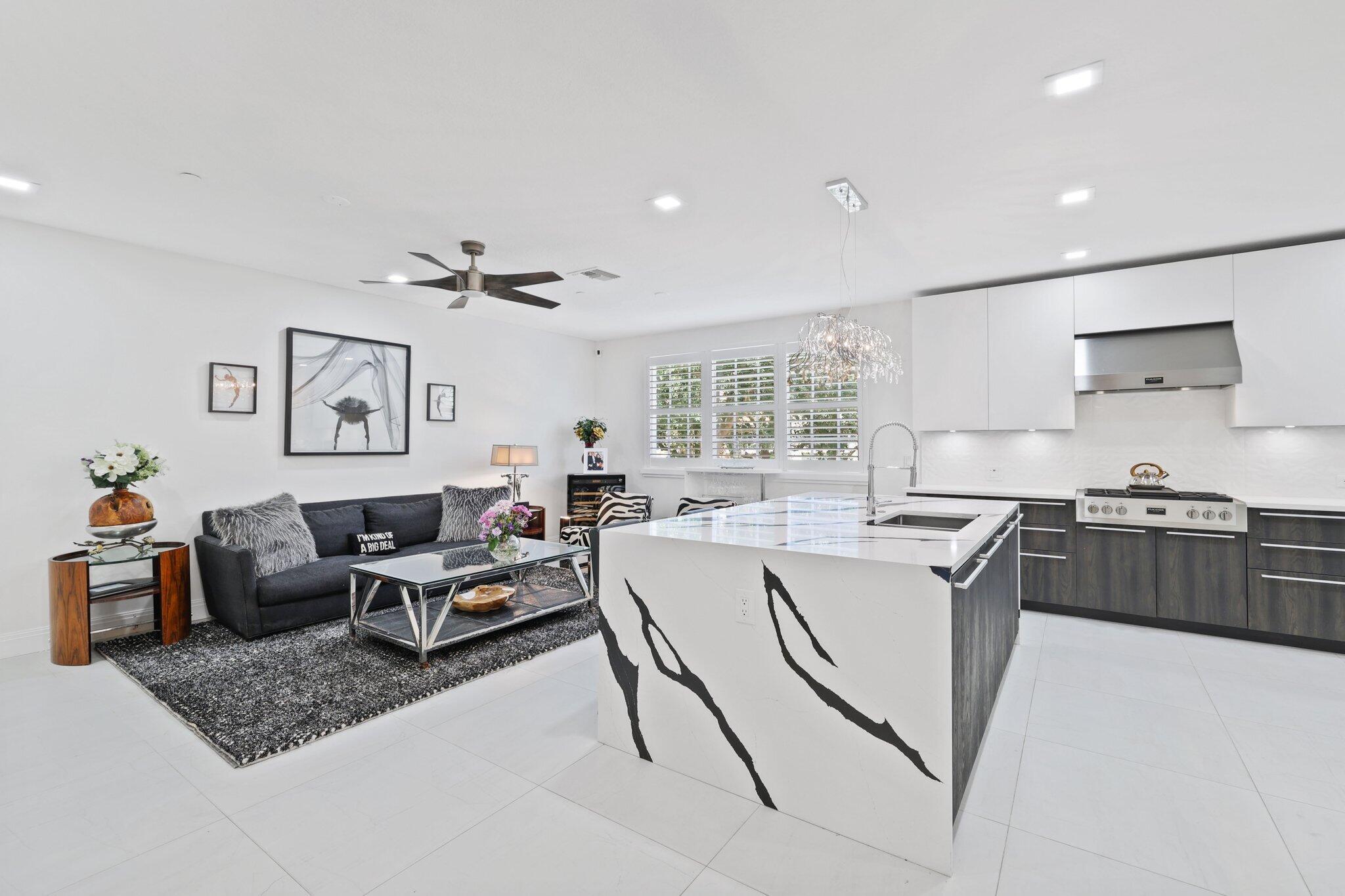 5530 Northeast Trieste Terrace, Unit 5530 Boca Raton, FL 33487 - Photo 24 of 57 a living room with furniture and a window