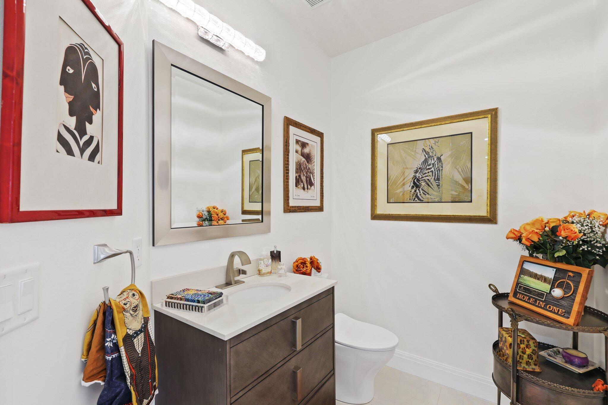 5530 Northeast Trieste Terrace, Unit 5530 Boca Raton, FL 33487 - Photo 25 of 57 a bathroom with a sink mirror vanity and toilet