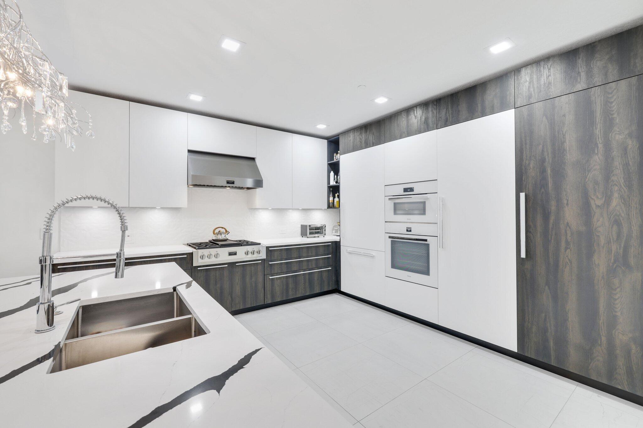 5530 Northeast Trieste Terrace, Unit 5530 Boca Raton, FL 33487 - Photo 26 of 57 a kitchen that has a sink cabinets and stainless steel appliances