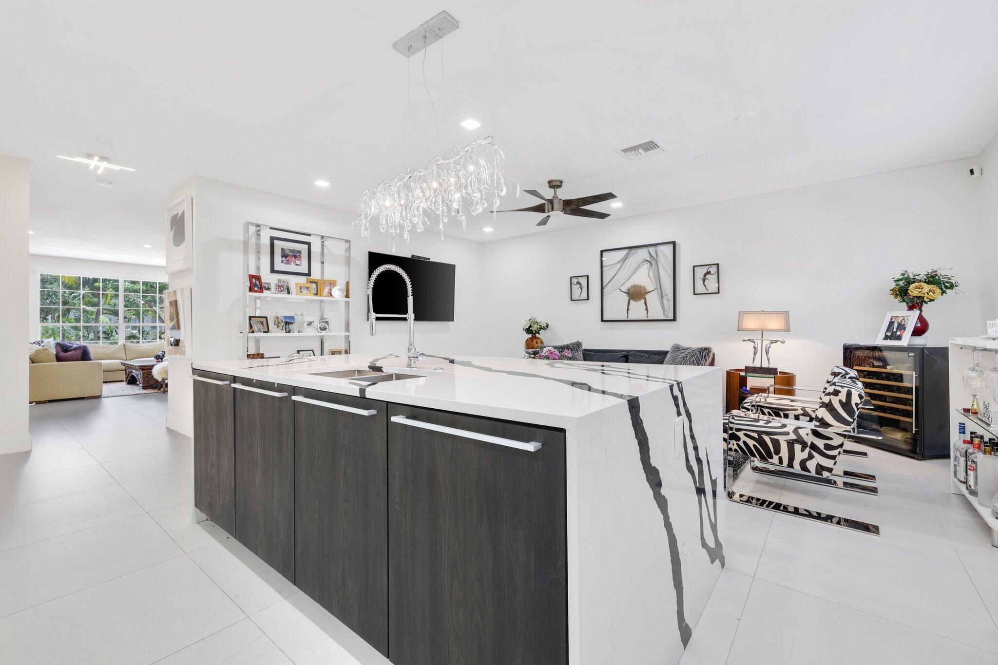 5530 Northeast Trieste Terrace, Unit 5530 Boca Raton, FL 33487 - Photo 29 of 57 a living room with furniture and a flat screen tv