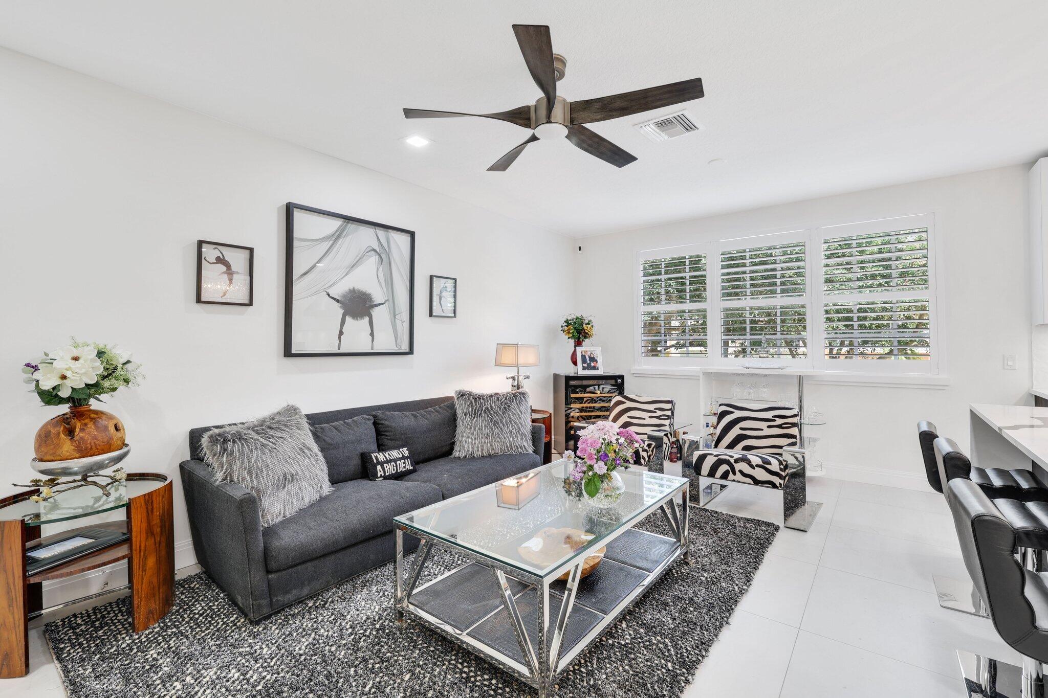 5530 Northeast Trieste Terrace, Unit 5530 Boca Raton, FL 33487 - Photo 32 of 57 a living room with furniture and a window