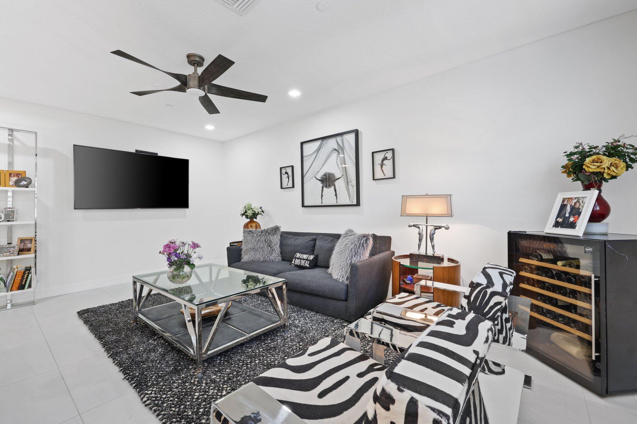 5530 Northeast Trieste Terrace, Unit 5530 Boca Raton, FL 33487 - Photo 33 of 57 a living room with furniture and a flat screen tv