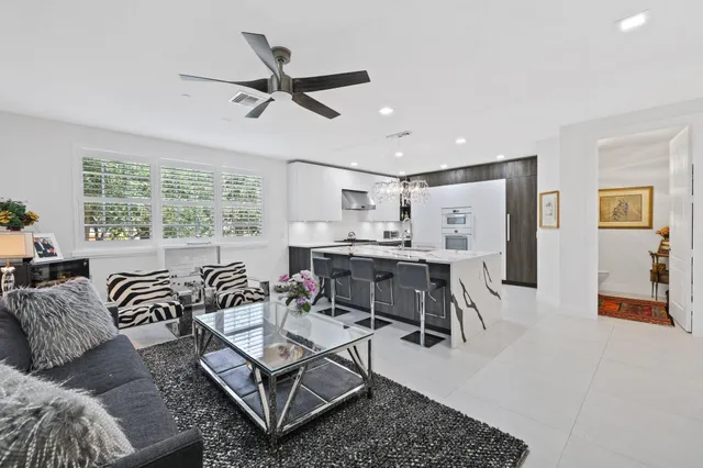 a living room with furniture and painting on the wall