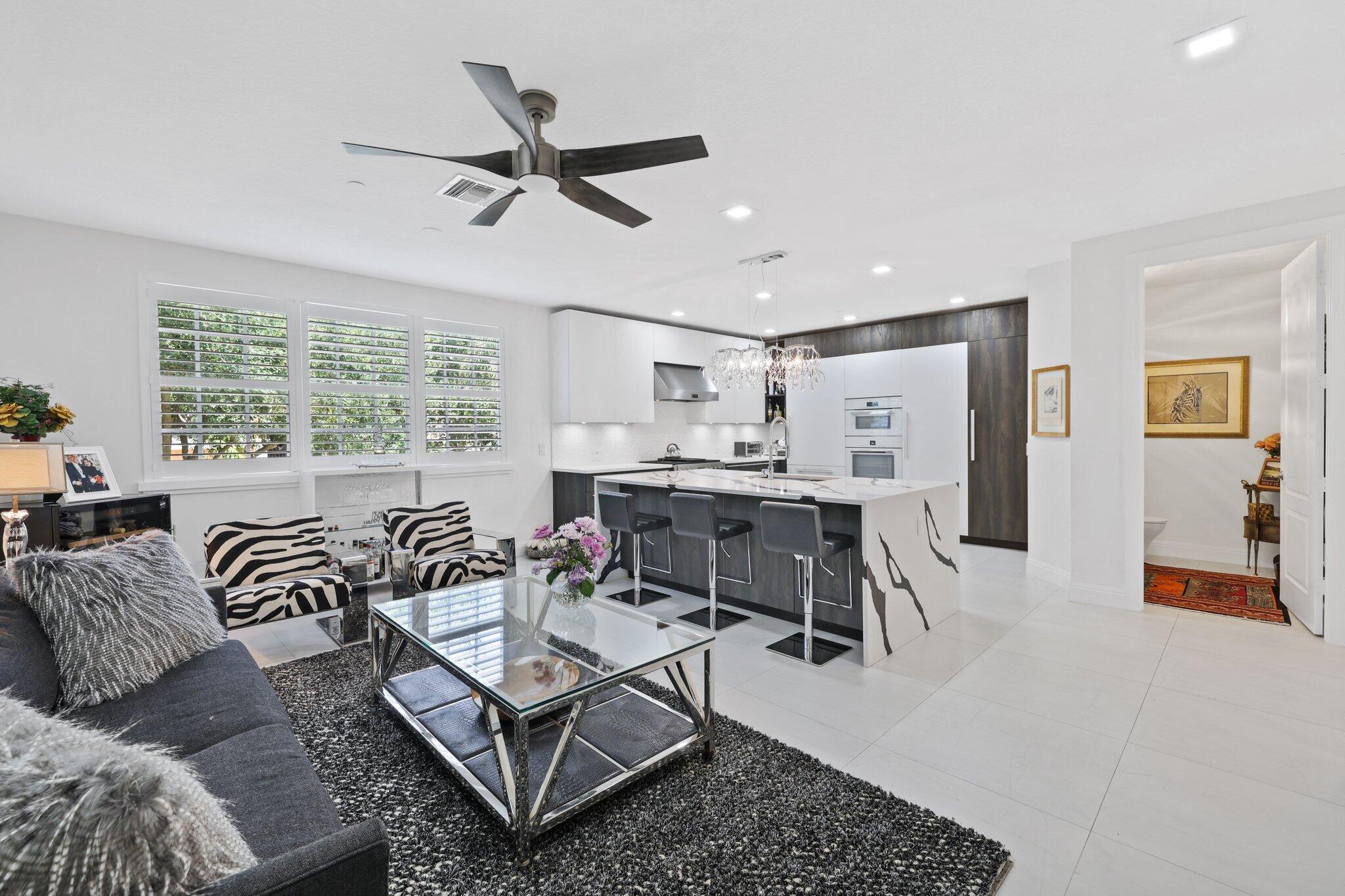 5530 Northeast Trieste Terrace, Unit 5530 Boca Raton, FL 33487 - Photo 34 of 57 a living room with furniture and a large window