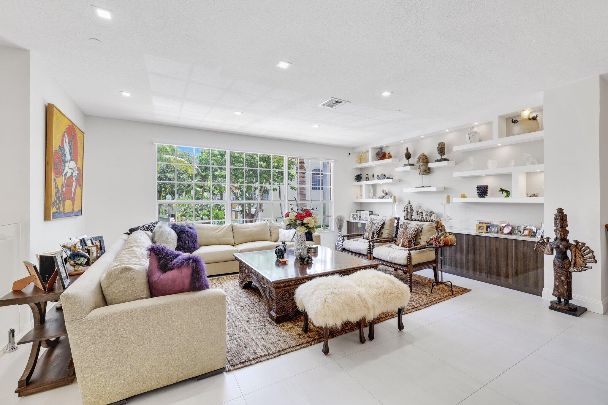 5530 Northeast Trieste Terrace, Unit 5530 Boca Raton, FL 33487 - Photo 36 of 57 a living room with furniture and a large window